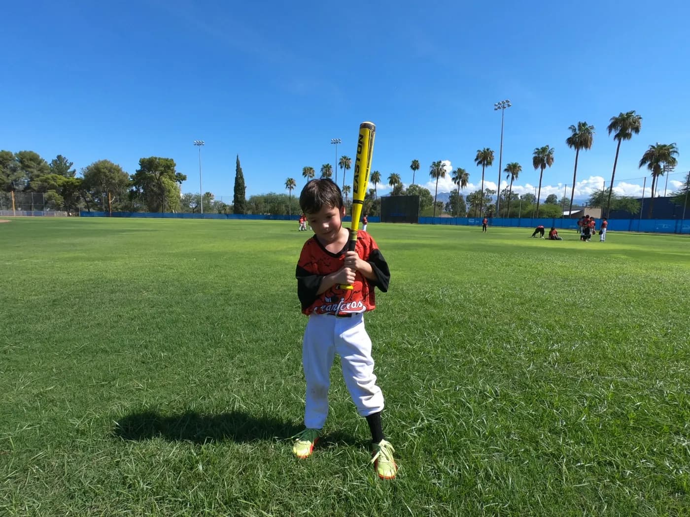Young camper at bat on the field